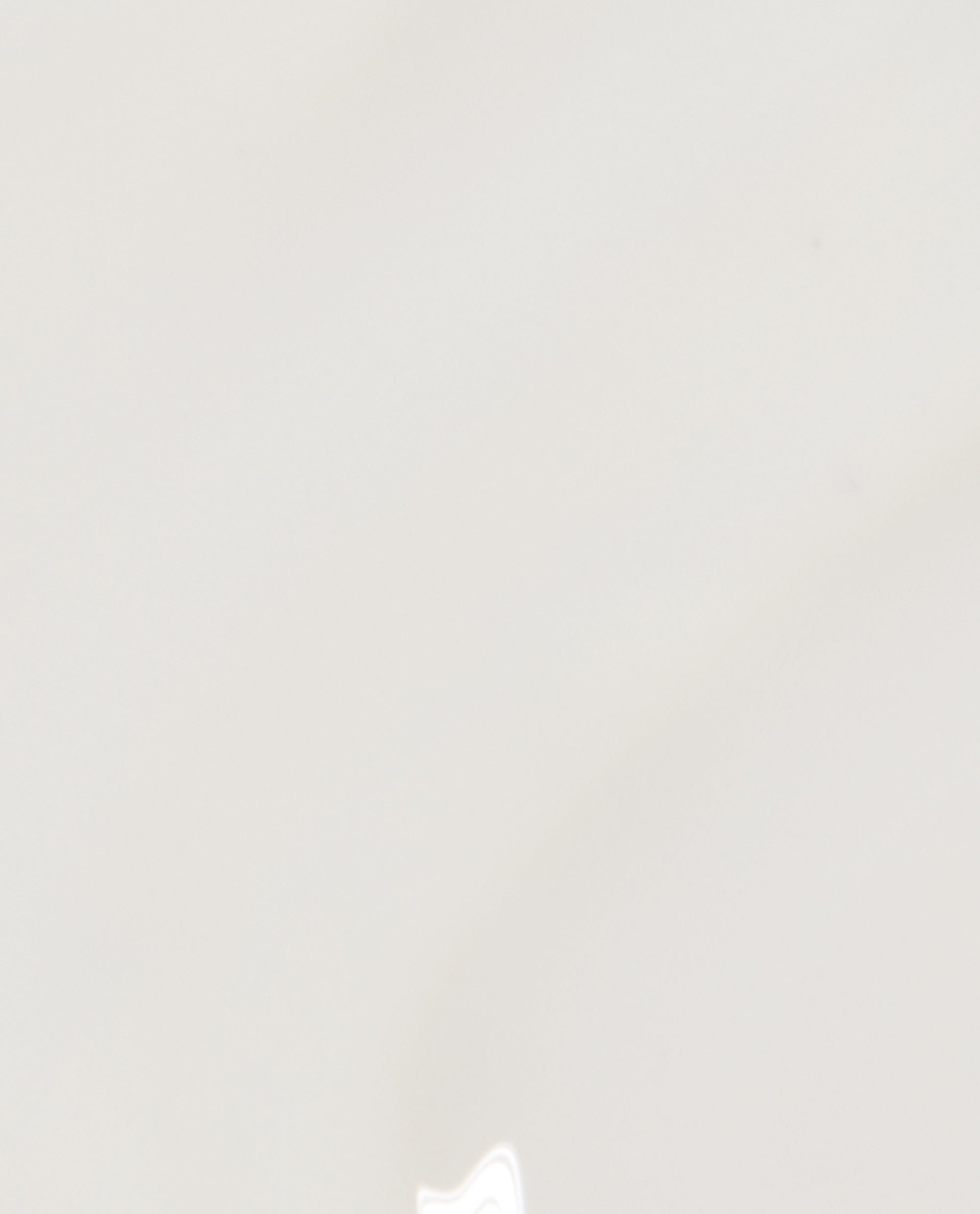 Funny Bunny® nail lacquer by OPI shown as a glossy sheer white nail polish swatch on a smooth background, highlighting its soft neutral shade ideal for a minimalist manicure or OPI nail polish gift set.