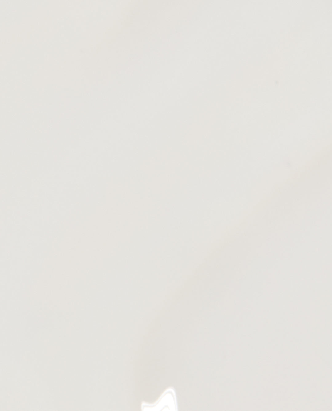 Funny Bunny® nail lacquer by OPI shown as a glossy sheer white nail polish swatch on a smooth background, highlighting its soft neutral shade ideal for a minimalist manicure or OPI nail polish gift set.